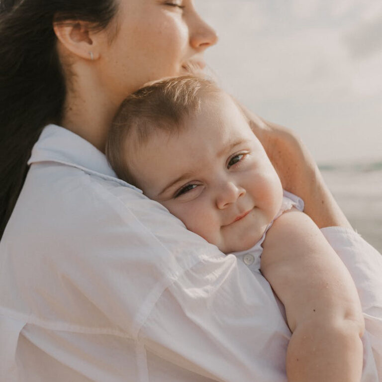 A mom hugging her baby while travelling on the road