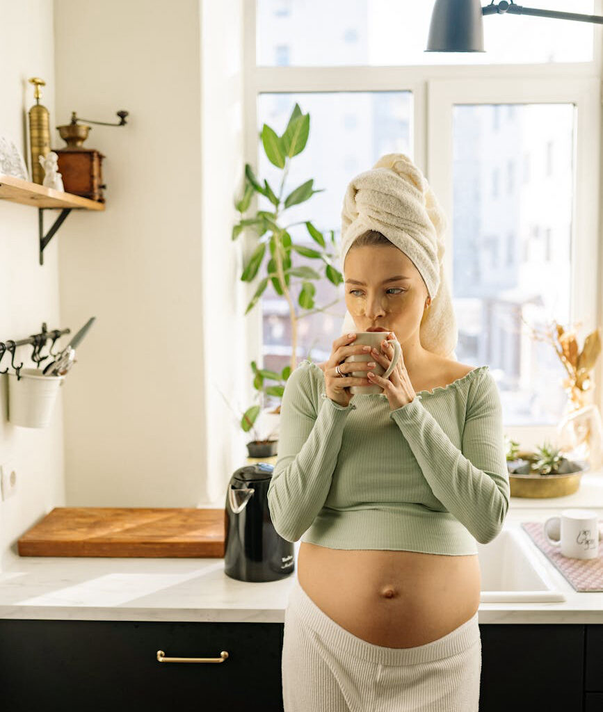 A pregnant woman drinking water to stay hydrated