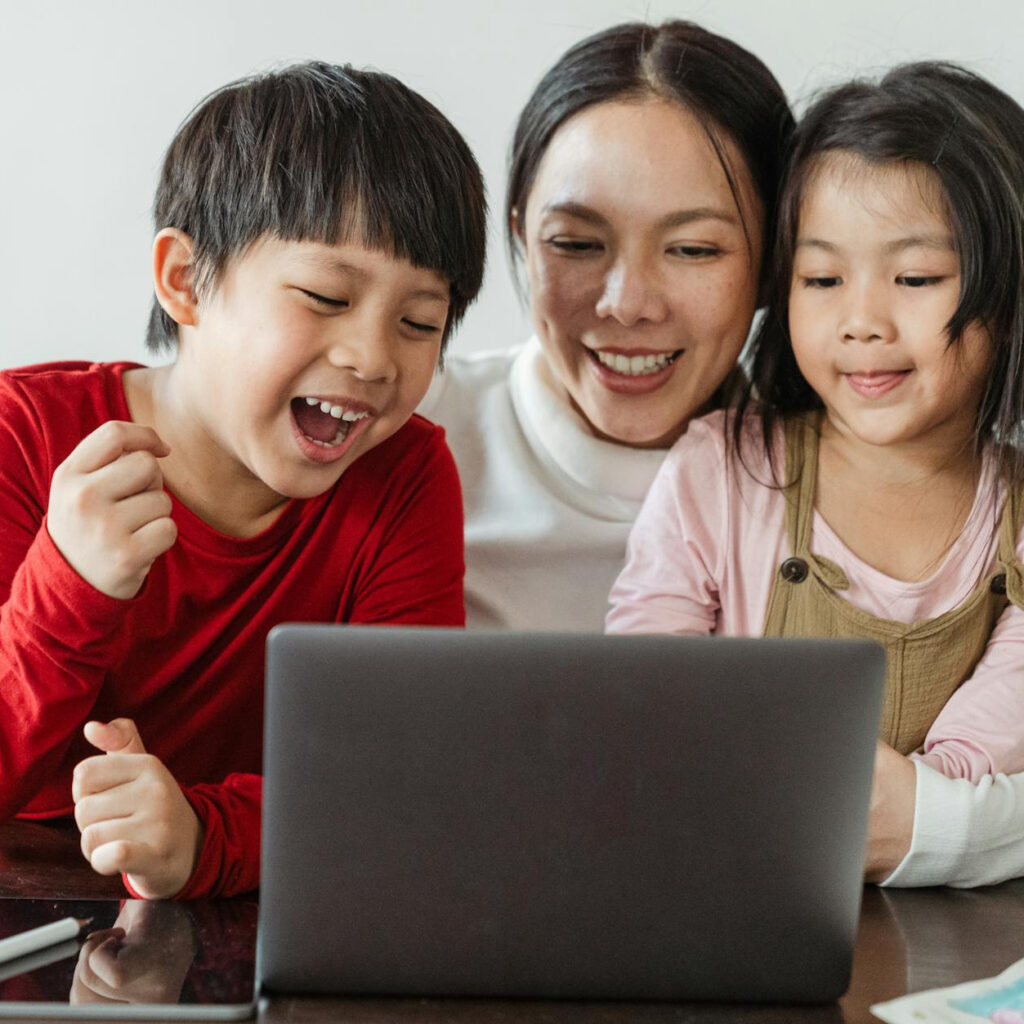 Excited mom entrepreneur with her kids surprised with joy